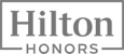 This image features the logo for Hilton Honors, a hotel loyalty rewards program, with 